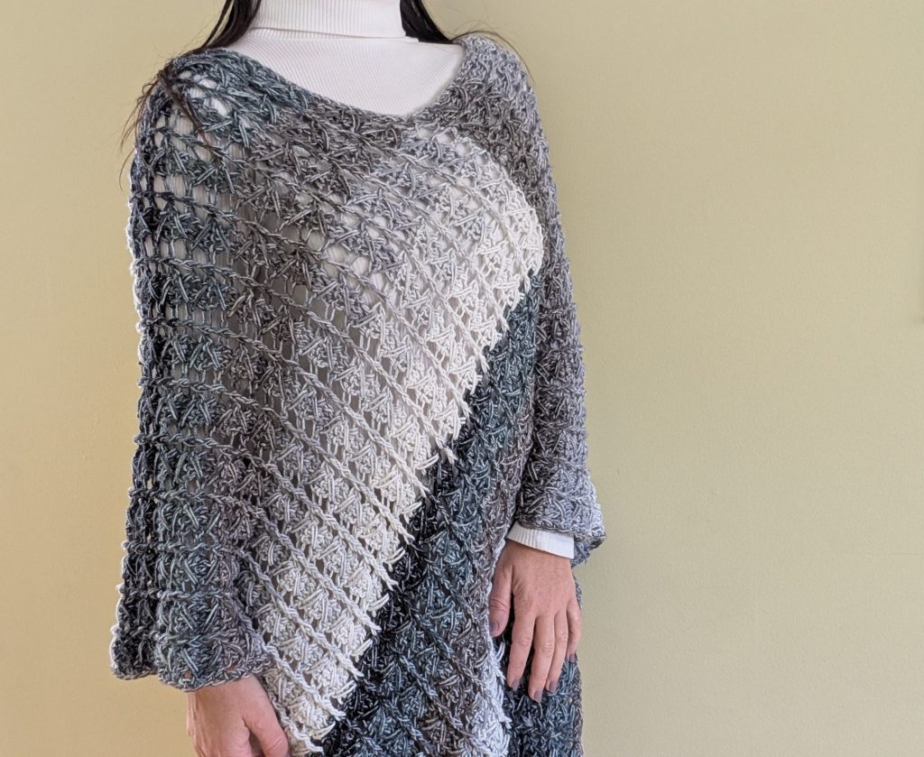 Crochet Poncho Pattern worn by a woman on a neutral background