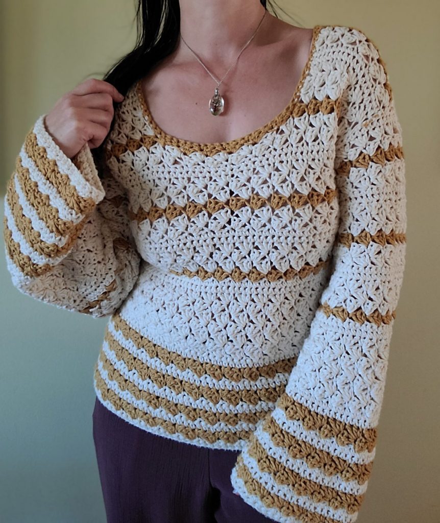 "Yellow beige striped crochet sweater, handmade, worn by woman."