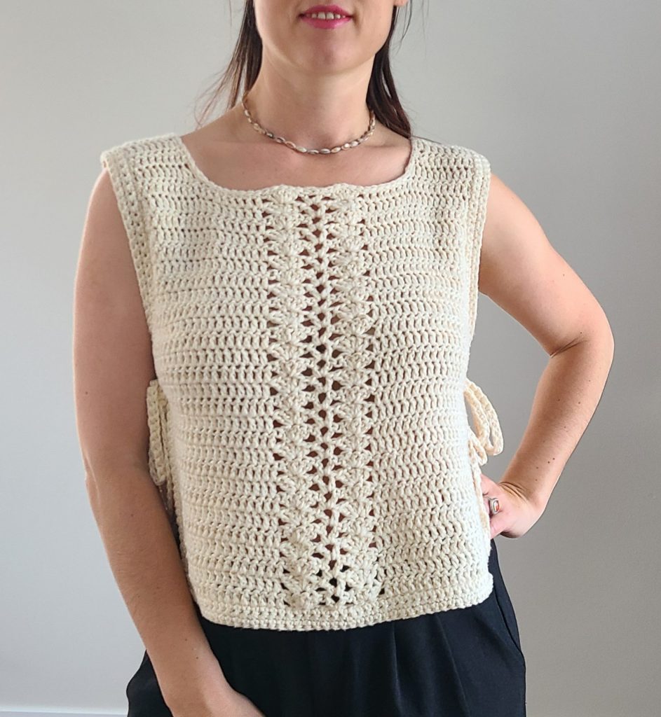 crochet beige tie vest worn by a woman