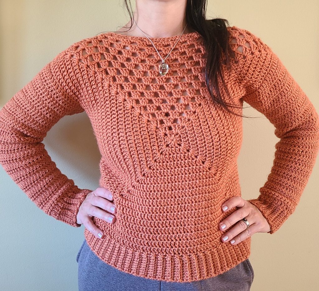 crochet orange granny square sweater worn by a woman