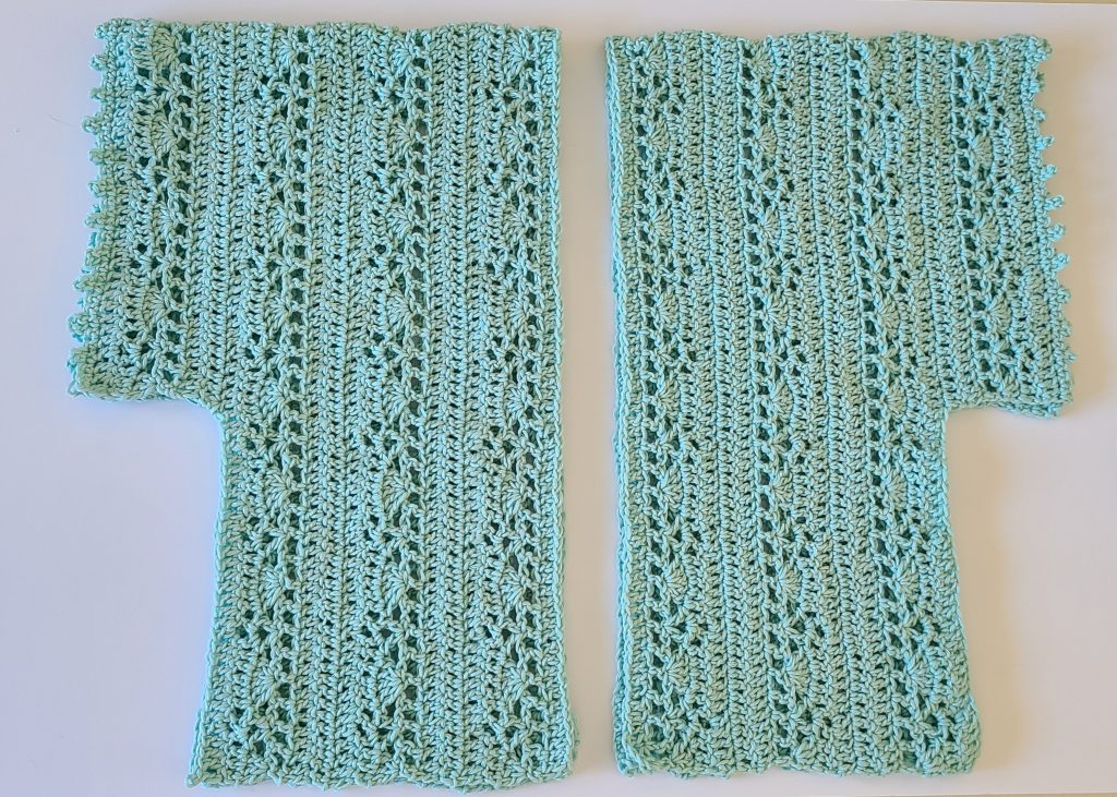 “Gina Crochet Lace Top panels laid flat on a white background, showing both main panel and sleeve pieces.”