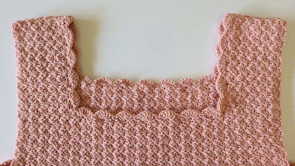 Close-up of the neck border of the Malvina Crochet Crop Top showing lace stitch detail