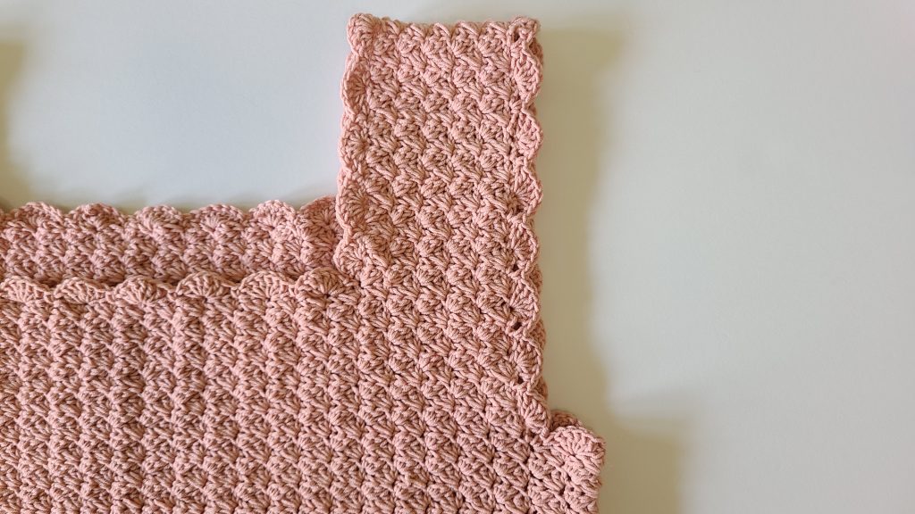 Close-up of the sleeve border of the Malvina Crochet Crop Top showing lace stitch detail