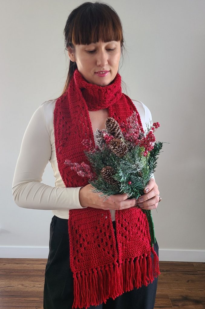 crochet granny square scarf worn by a woman on a white background