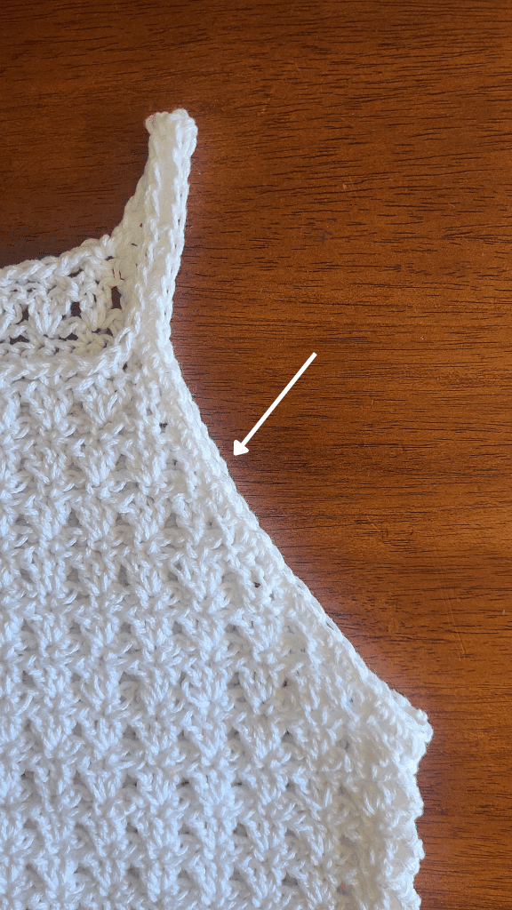 Crochet tank top strap detail showing clean edge finish left side