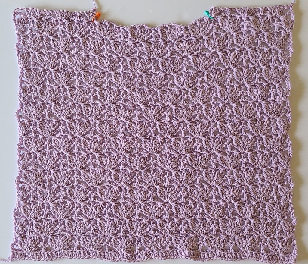 Front panel of Lavinia Crochet Lacy Top worked flat in repeating lace stitch pattern