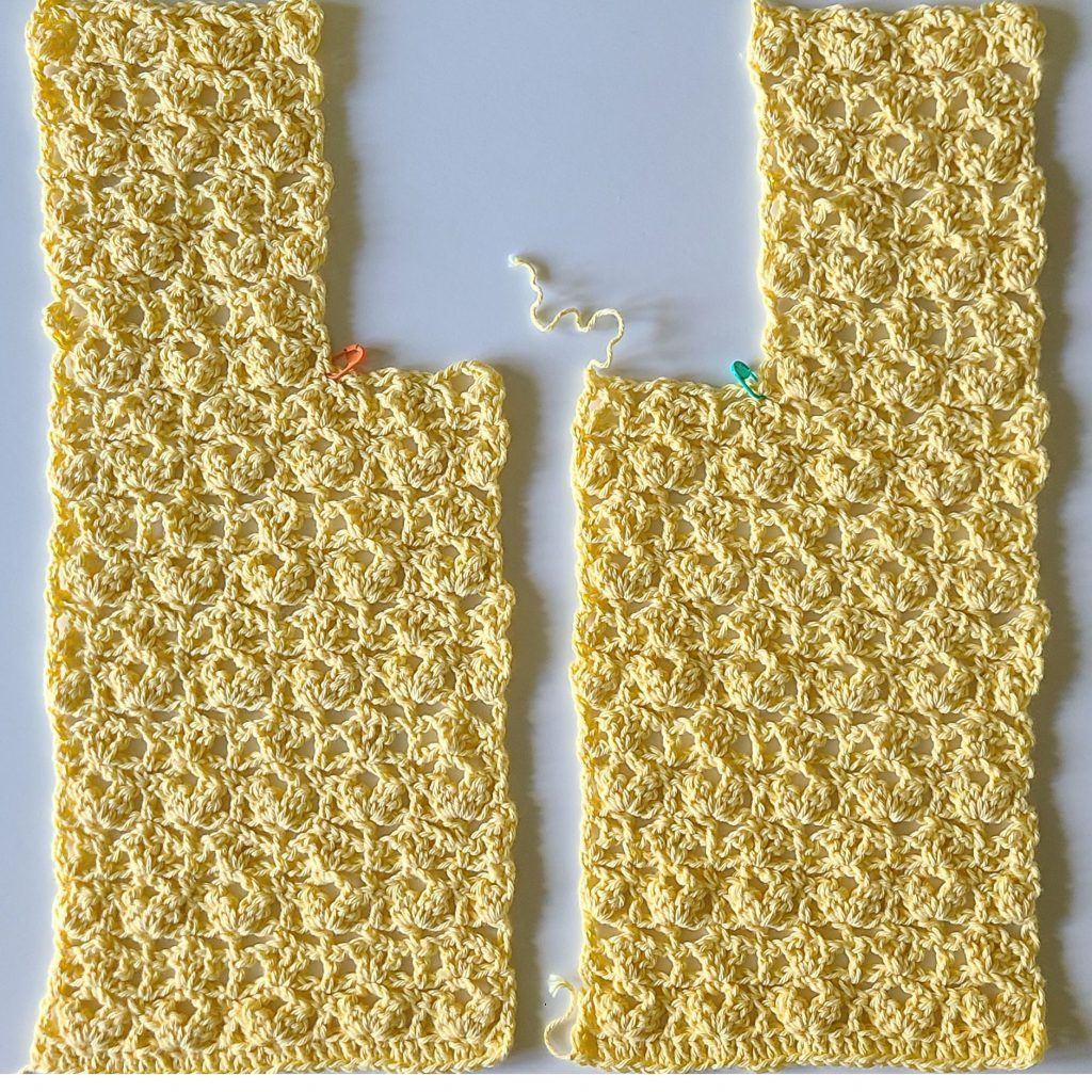 two crochet vest front panels with arm shaping and stitch detail