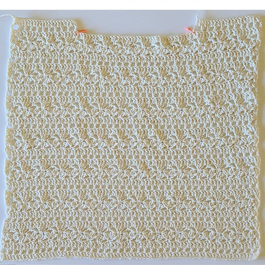 Front panel of a summer lace crochet top with textured openwork stitch design