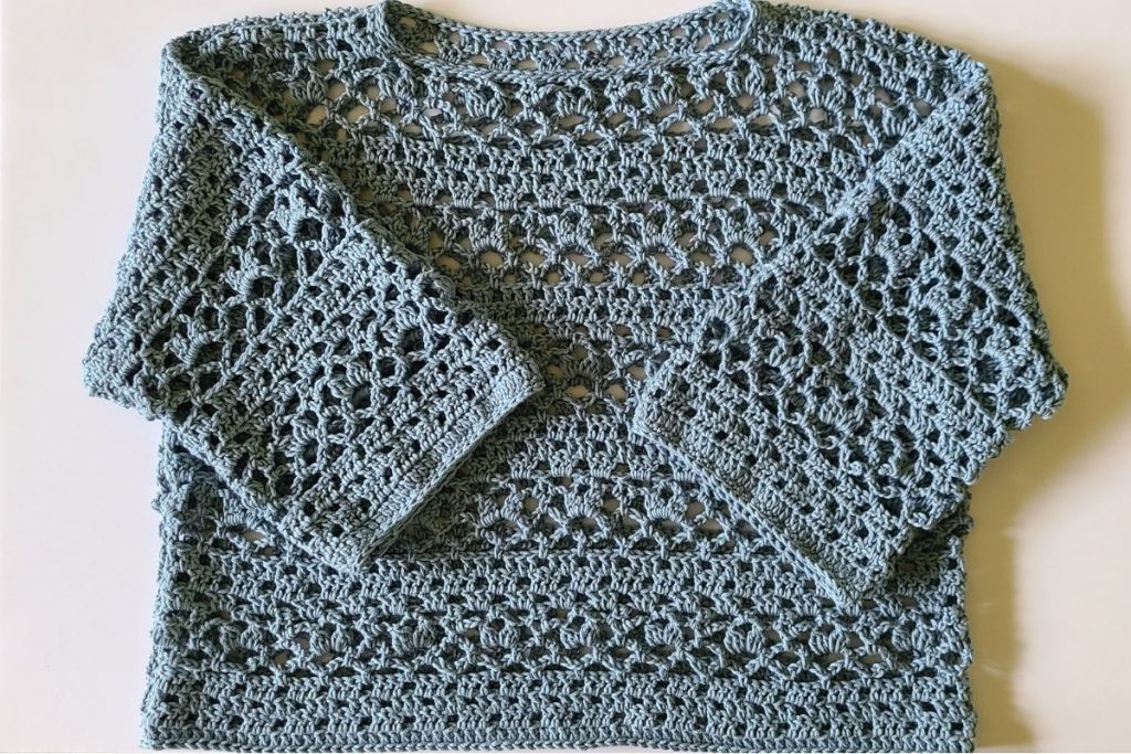 finished crochet lace top worn with relaxed fit and 3/4 sleeves