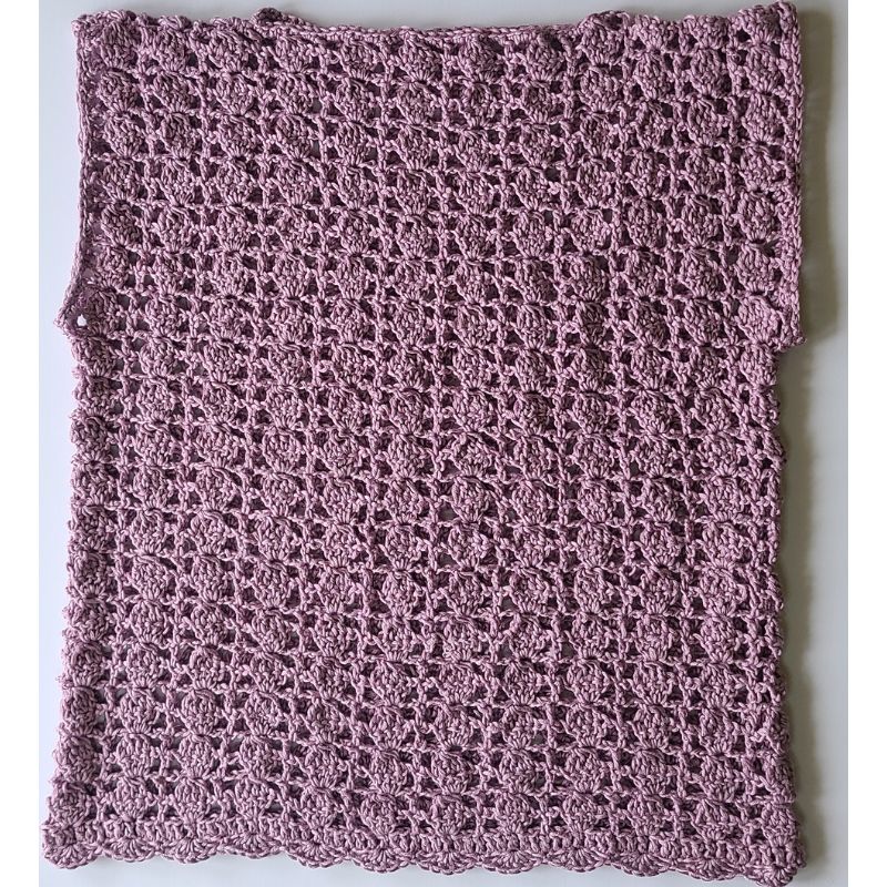 Finished crochet lace top laid flat showing full lace stitch pattern