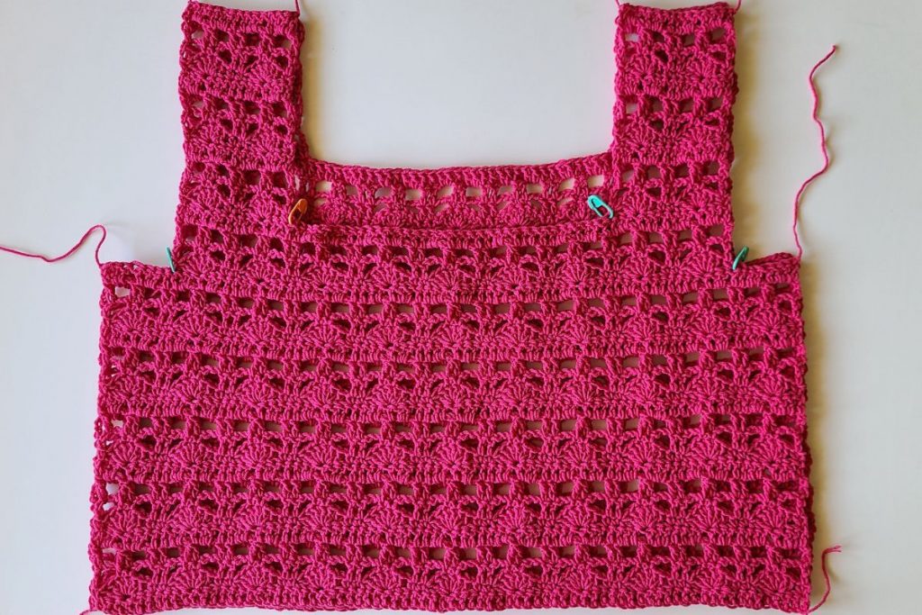 Front and back panels of the Myla Crochet Lace Crop Top aligned and ready to be seamed at the shoulders and sides.