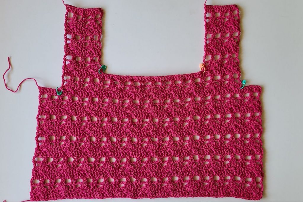 Front panel of the Myla Crochet Lace Crop Top featuring a square neckline and shoulder straps worked in a lacy shell stitch pattern.