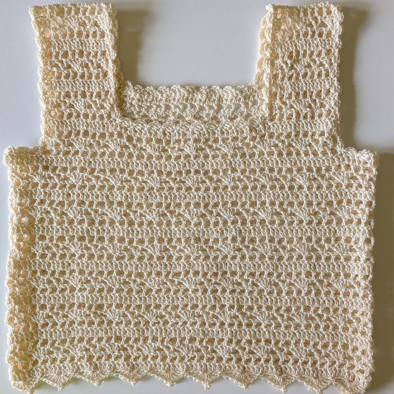 Finished Aviana Crochet Lace Top laid  flat on a white background