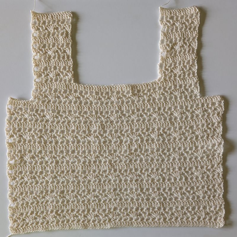 Front panel of the Aviana Crochet Lace Top laid flat before assembly.