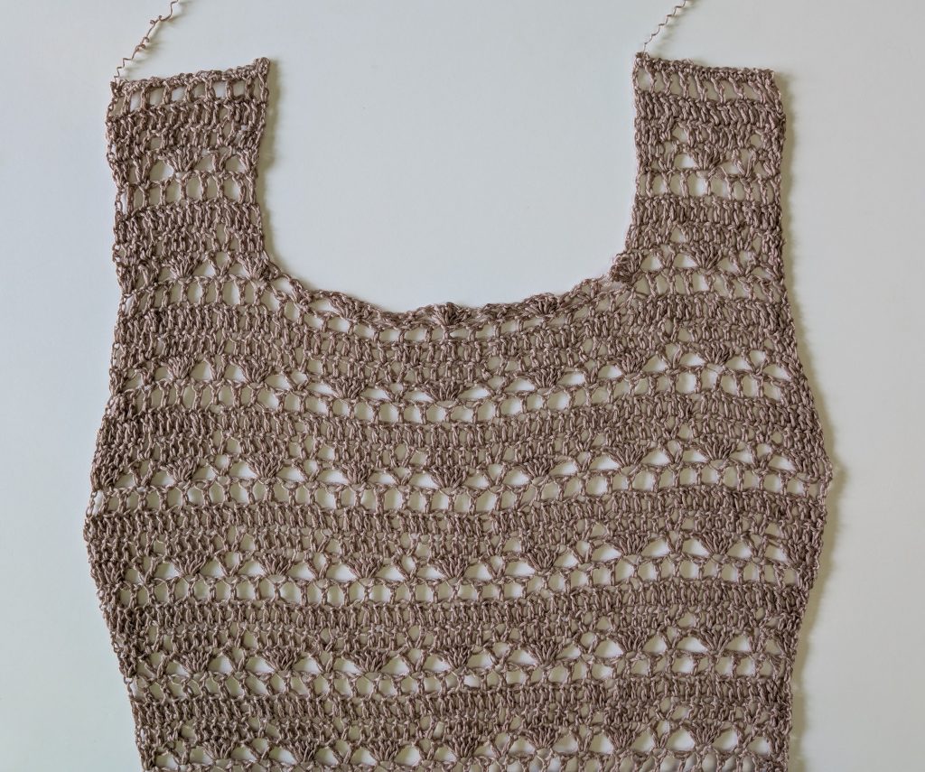 Front panel of the Sorelya crochet lace dress featuring a square neckline, shoulder straps, and lace stitch pattern.