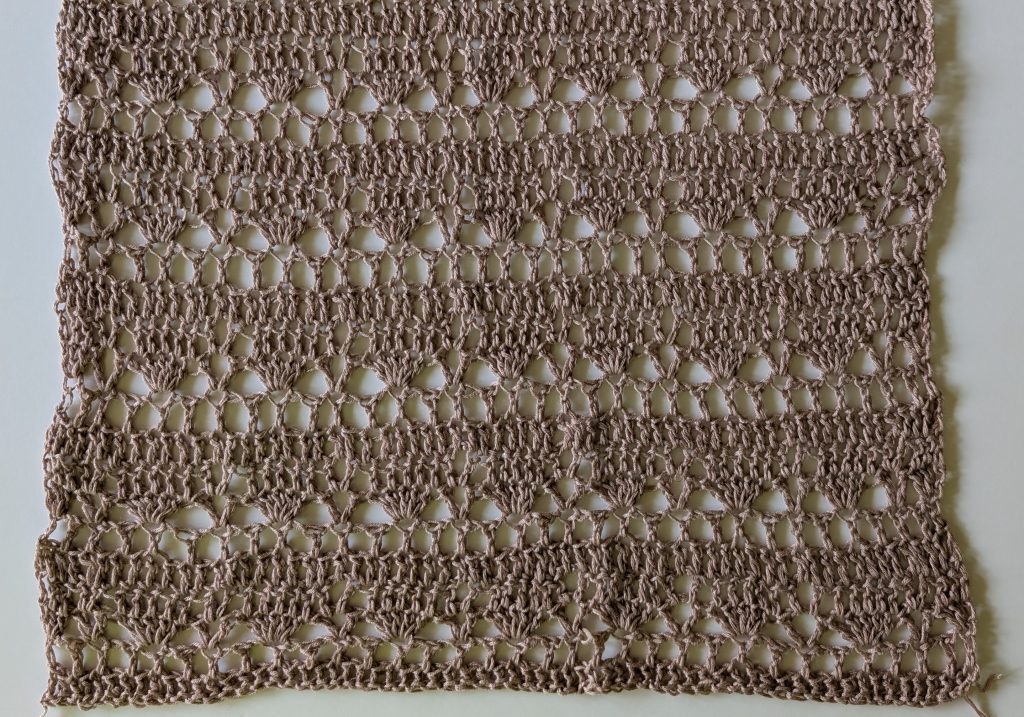 Close-up of the Sorelya crochet lace stitch pattern featuring an openwork shell design with double crochet stitches and chain spaces.