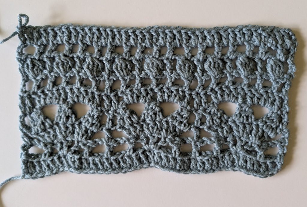 Gauge swatch for the Allana Crochet Lace Top showing the lace stitch pattern used in the project.