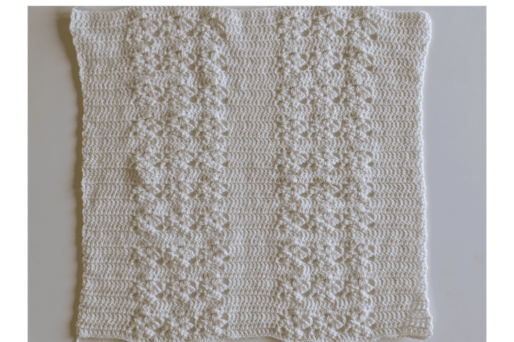 Back panel of the Aryna Crochet Cardigan featuring a repeating lace stitch pattern