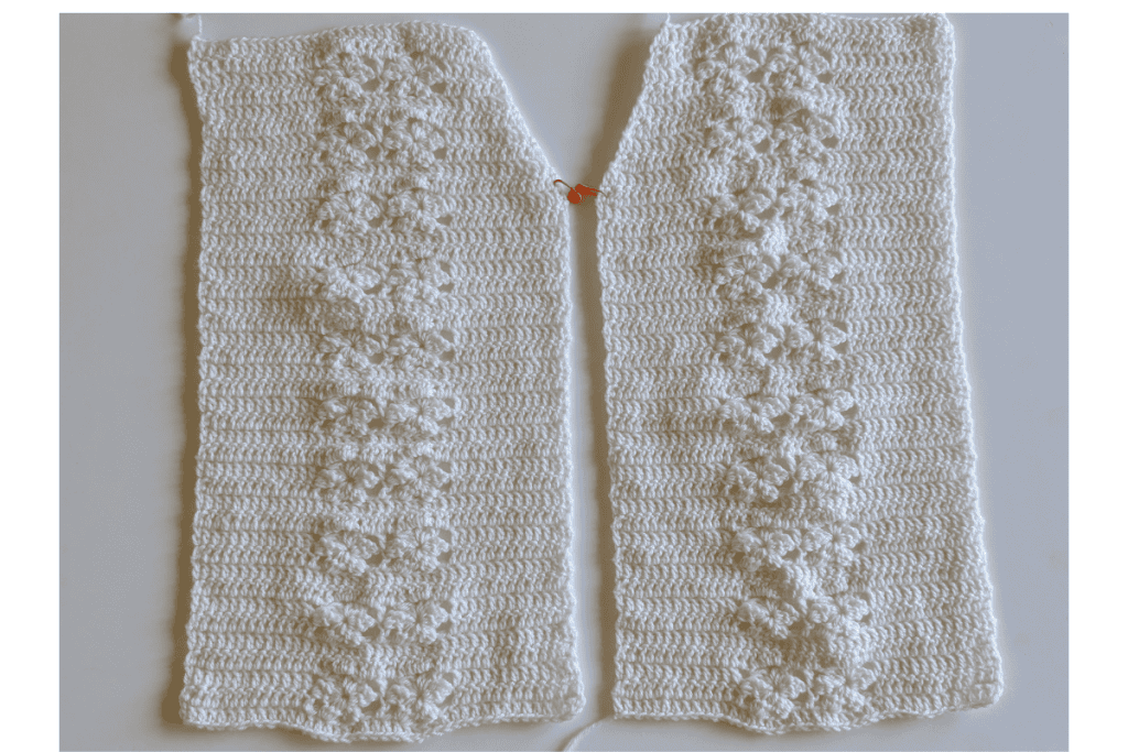 Two front panels of the Aryna Crochet Cardigan showing the lace stitch and neckline shaping