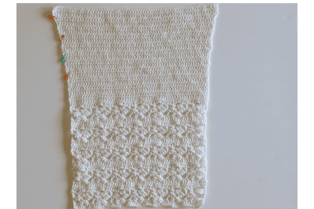 One crocheted sleeve for the Aryna Crochet Cardigan featuring a lace stitch pattern